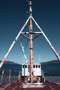 Low angle view of sailboat on beach against clear sky