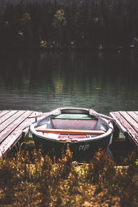 Abandoned boat moored in lake