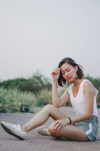 Young woman sitting on mobile phone