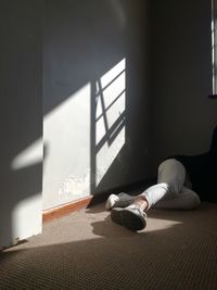 Low section of person on table by window at home