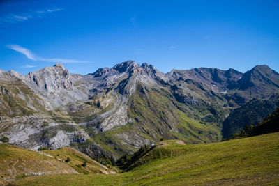 Scenic view of mountains against blue sky