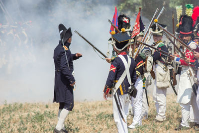 Full length of men on field