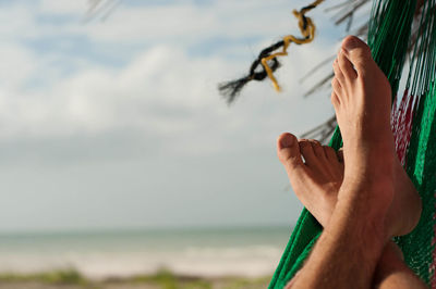Cropped image of woman looking through window