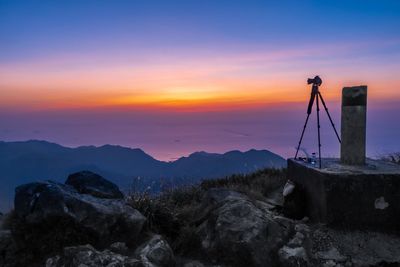 Silhouette of mountain against cloudy sky during sunset