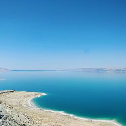 Scenic view of sea against clear blue sky