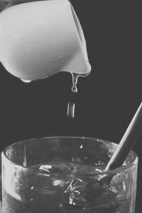 Close-up of drink in glass against black background