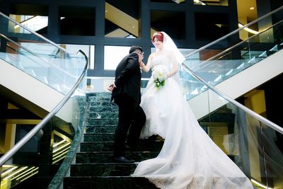 Couple standing on staircase of building