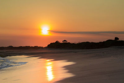 Scenic view of sea against romantic sky at sunset