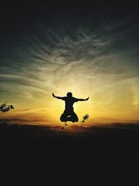 Silhouette of jumping jumping at sunset