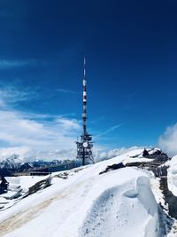 Snow covered tower against sky