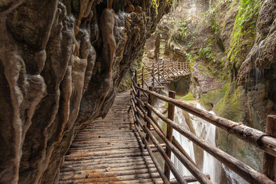 Stalactites above the walkway in caves carved out of sandstone, grotte del caglieron, veneto, italy