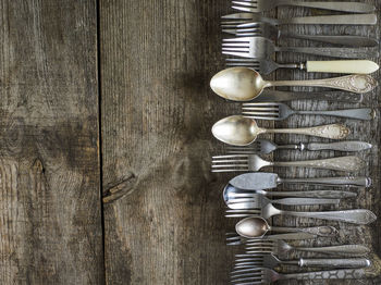 Directly above shot of old cutlery on wooden table