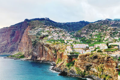 Panoramic view of townscape by sea against sky