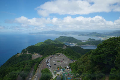 Scenic view of sea and mountains against sky