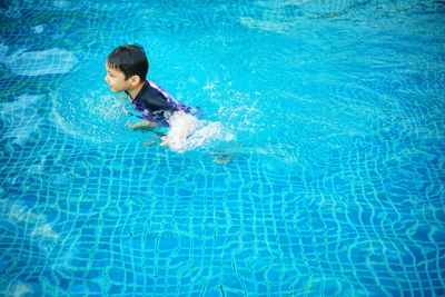 Boy swimming in pool