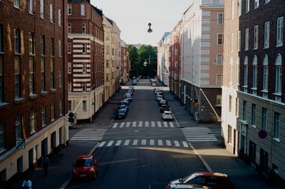 Traffic on road amidst buildings in city