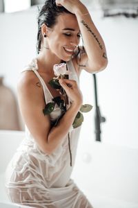 Young woman looking at camera at home