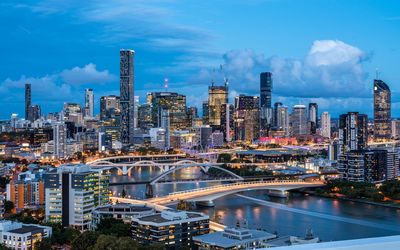 Aerial view of buildings in city against sky