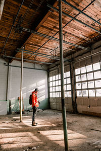 Side view of young man photographing in abandoned room