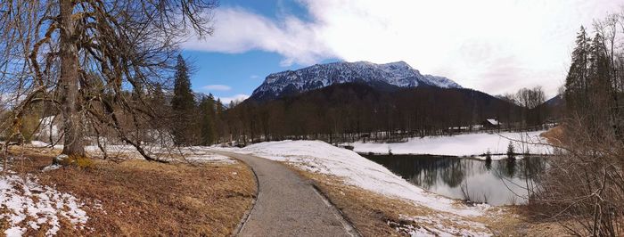 Scenic view of snowcapped mountains by lake against sky