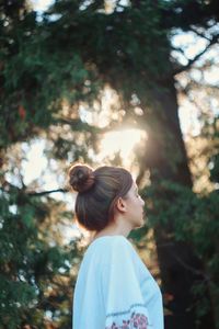 Side view of a girl looking away in forest