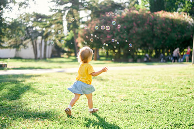 Full length of girl on field in park