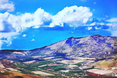 Scenic view of mountains against cloudy sky