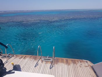 View of swimming pool by sea against sky