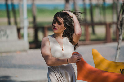 Beautiful young woman standing in a park