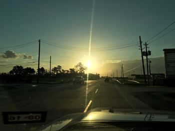 Cars on road at sunset