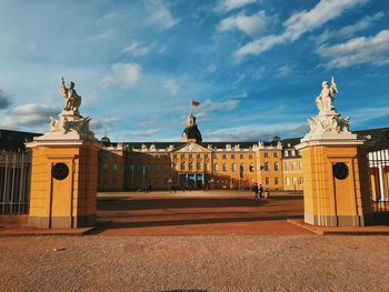 Statue of historic building against cloudy sky