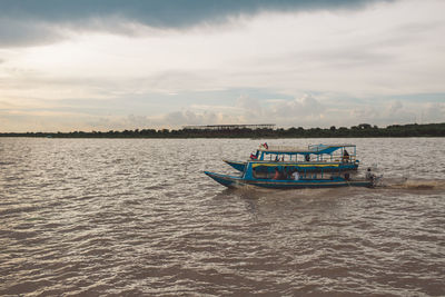 Boat sailing in sea against sky