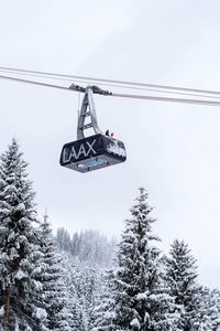 Low angle view of overhead cable car against sky