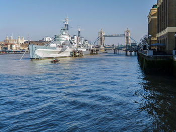 Boats in sea against sky in city