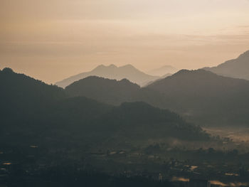 Scenic view of silhouette mountains against sky during sunset