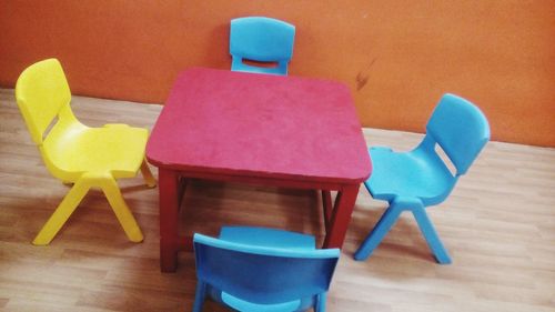 Close-up of empty chairs on table