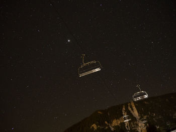 Ski lifts against star field at night