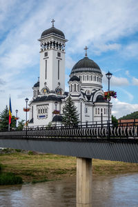 Church by building against sky