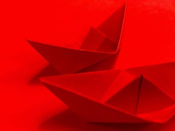 High angle view of paper design on red background