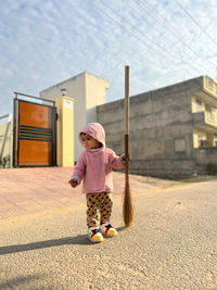 Rear view of woman standing on street