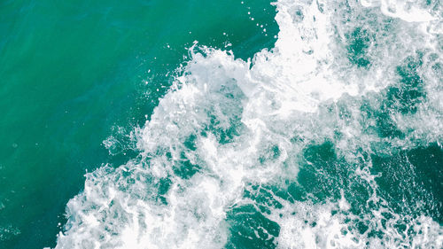 High angle view of waves splashing on sea