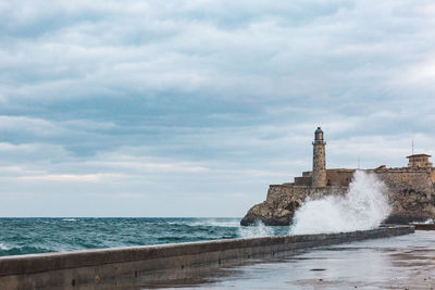 Scenic view of sea against cloudy sky