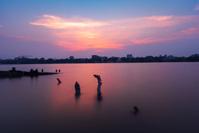 Scenic view of lake against sky during sunset
