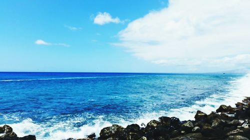 Scenic view of sea against cloudy sky