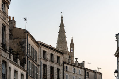 Low angle view of buildings against clear sky in city