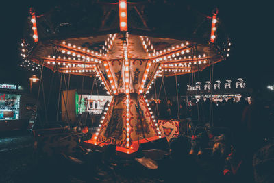 Illuminated amusement park ride at night