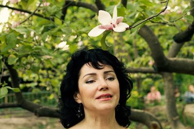 Portrait of woman with flower tree