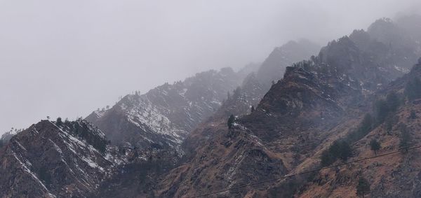 Scenic view of mountains against sky during winter