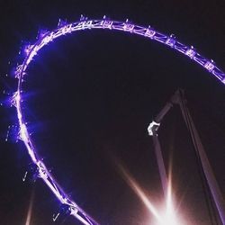 Low angle view of illuminated ferris wheel