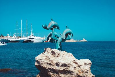 Panoramic view of sea against clear blue sky